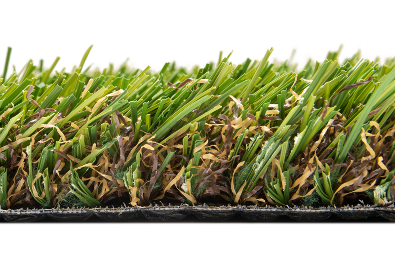Side view of artificial turf showing small varyied colored fibers