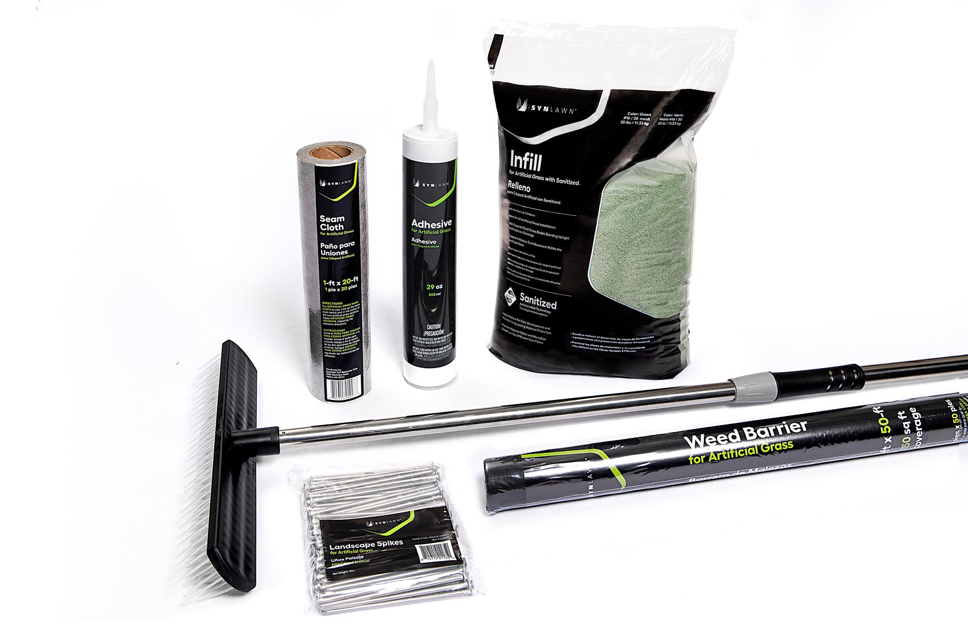 A range of tools for artificial grass on a white floor with white backdrop